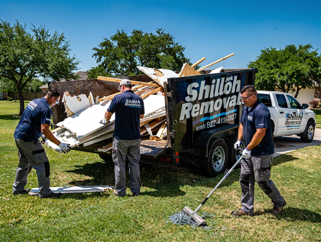 Safe loading of construction debris into Shiloh Junk Removal trailer