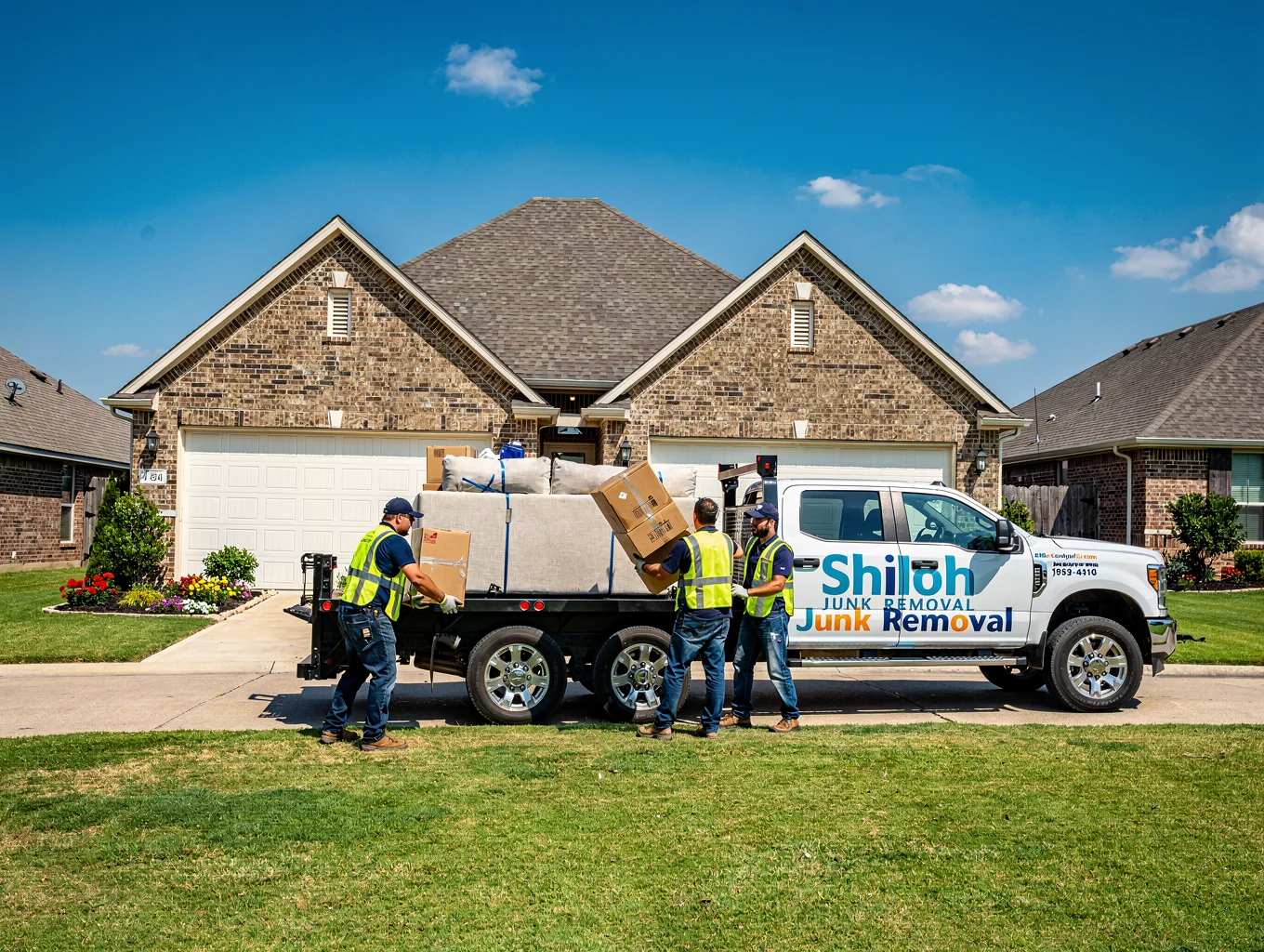 Junk removal truck servicing a residential property in Weatherford Texas